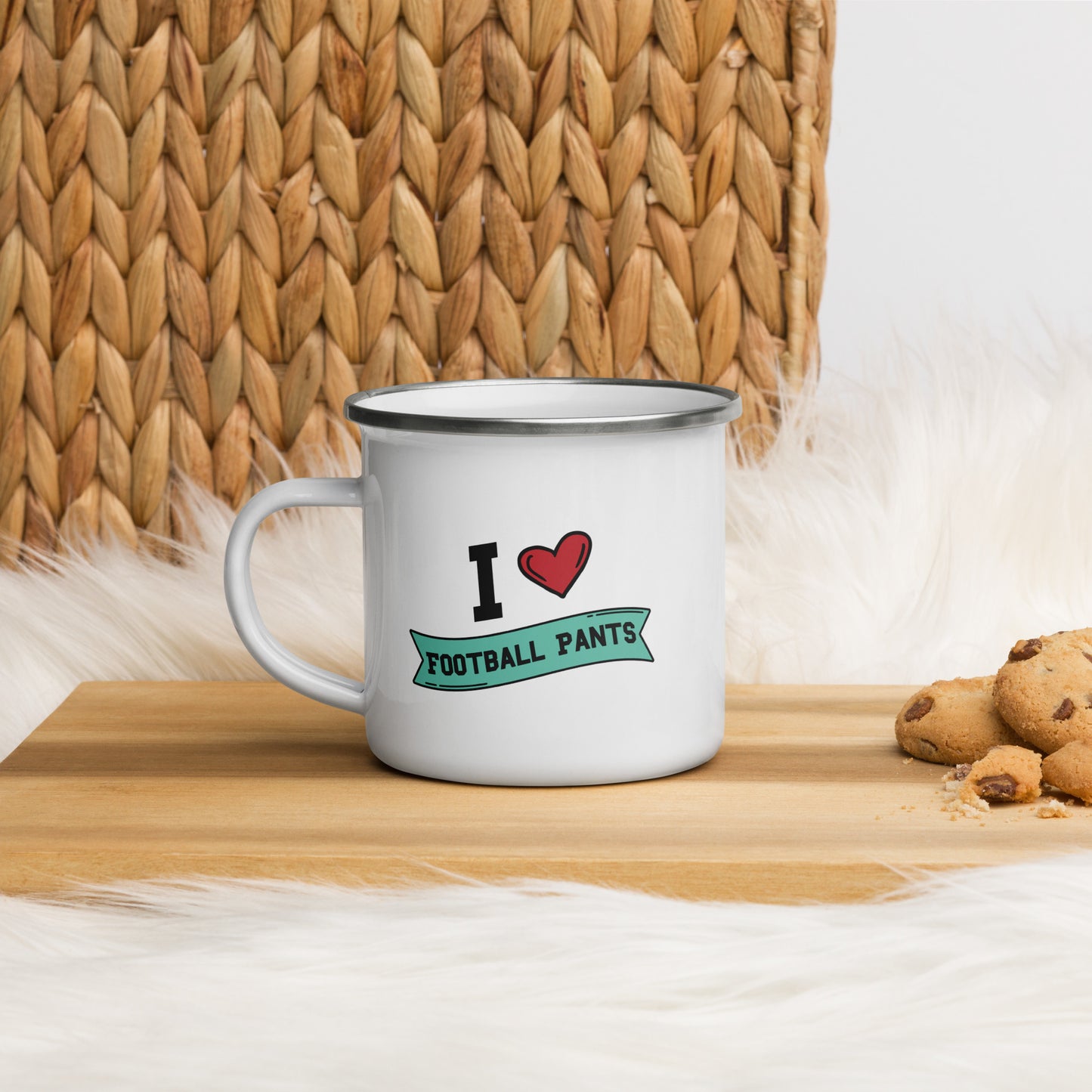 A white Enamel Mug that reads "I Heart Football Pants", Football Pants is in a green banner and the design features a large red heart.