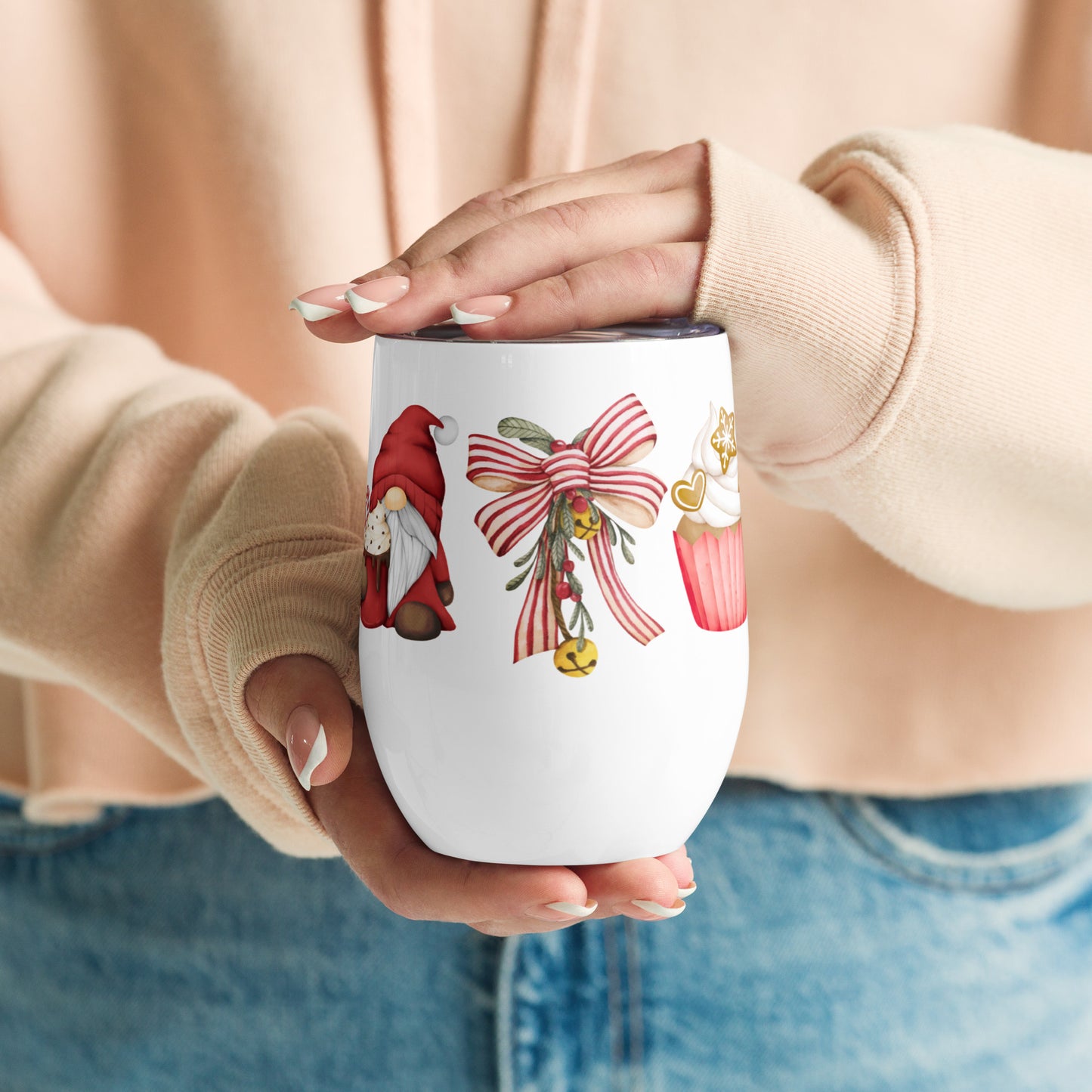 A white tumbler with a garden gnome, bow, and a cupcake