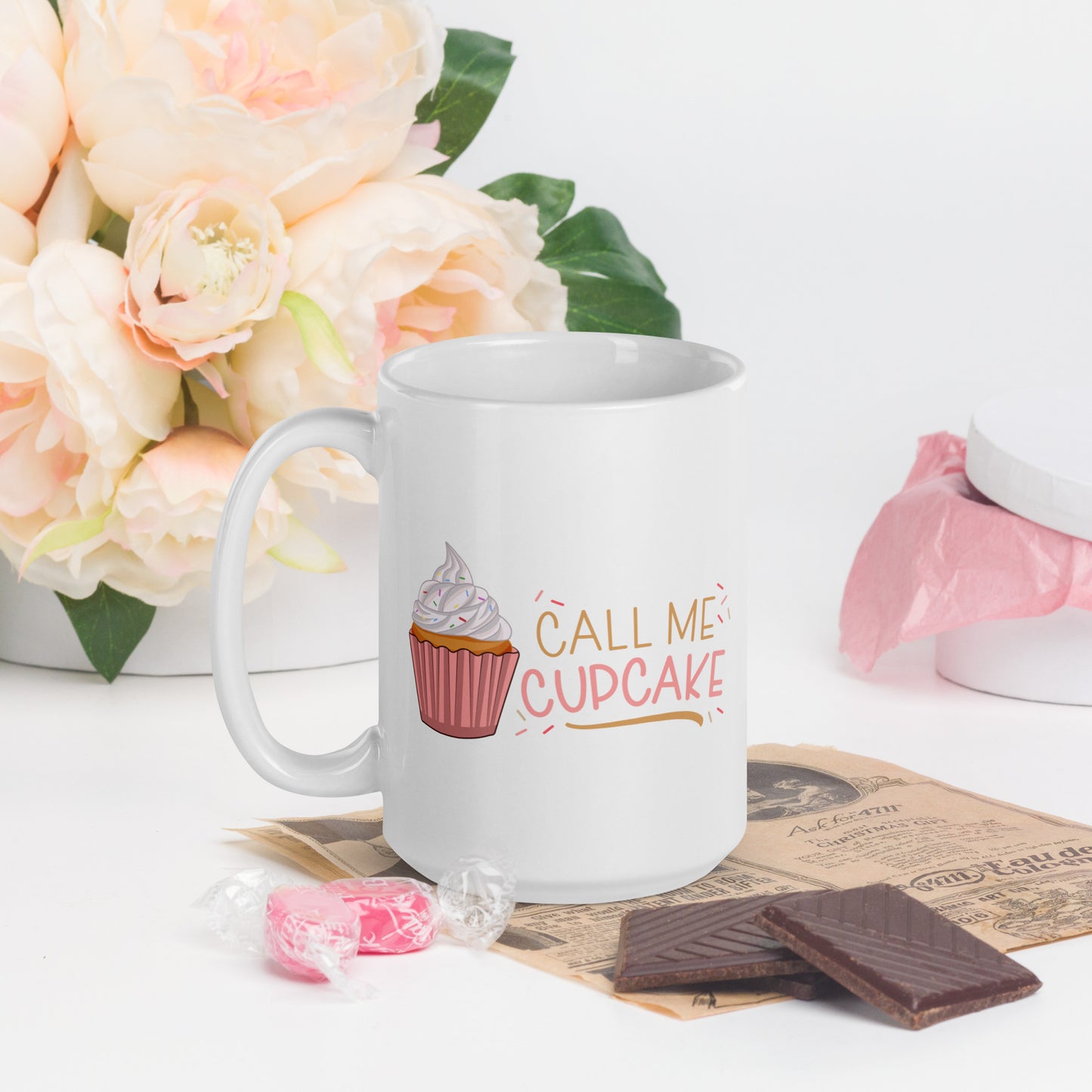 a white coffee mug with a cupcake logo and the words Call ME Cupcake