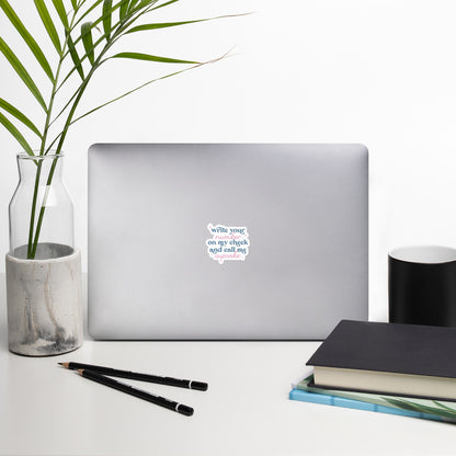 A sticker with blue and pink text, a combination of print and cursive that reads "Write Your Number on my cheek and call me cupcake". The sticker is 4 x 4 inches