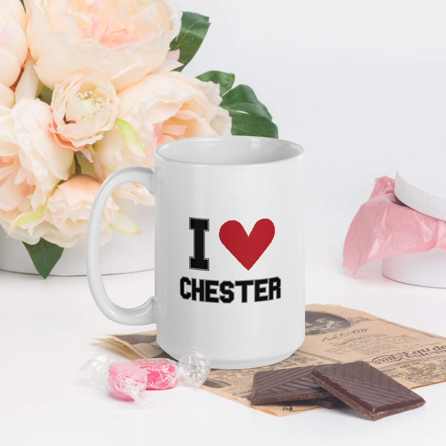A white mug  that reads "I Heart Chester" in black letters, with a large red heart 