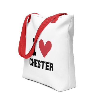 a red-strapped white tote bag that reads I Heart Chester