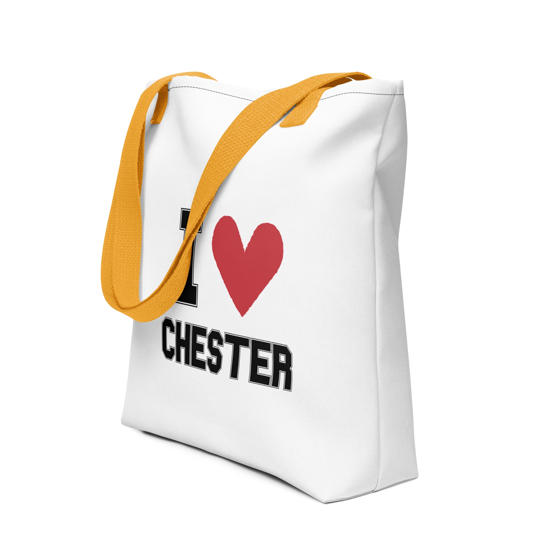 a yellow-strapped white tote bag that reads I Heart Chester