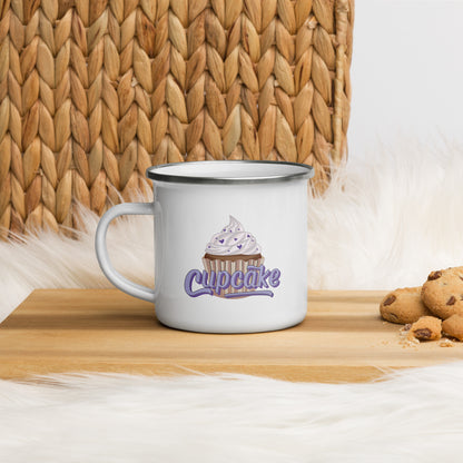 A white enamel mug with a cupcake logo. The cupcake logo is a large cupcake covered in sprinkles, with cupcake written over it in pink block letters 