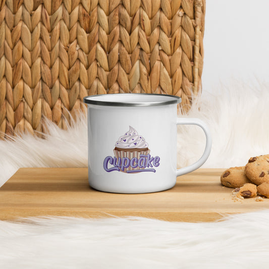 a white enamel mug with a large cupcake logo. The cupcake logo is a large cupcake covered in sprinkles, with cupcake written over it in pink block letters 