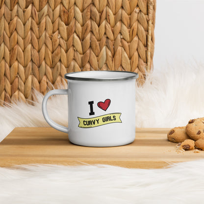A white enamel coffee mug that reads "I Heart Curvy Girls", Curvy Girls is in a yellow banner and the design features a large red heart. 