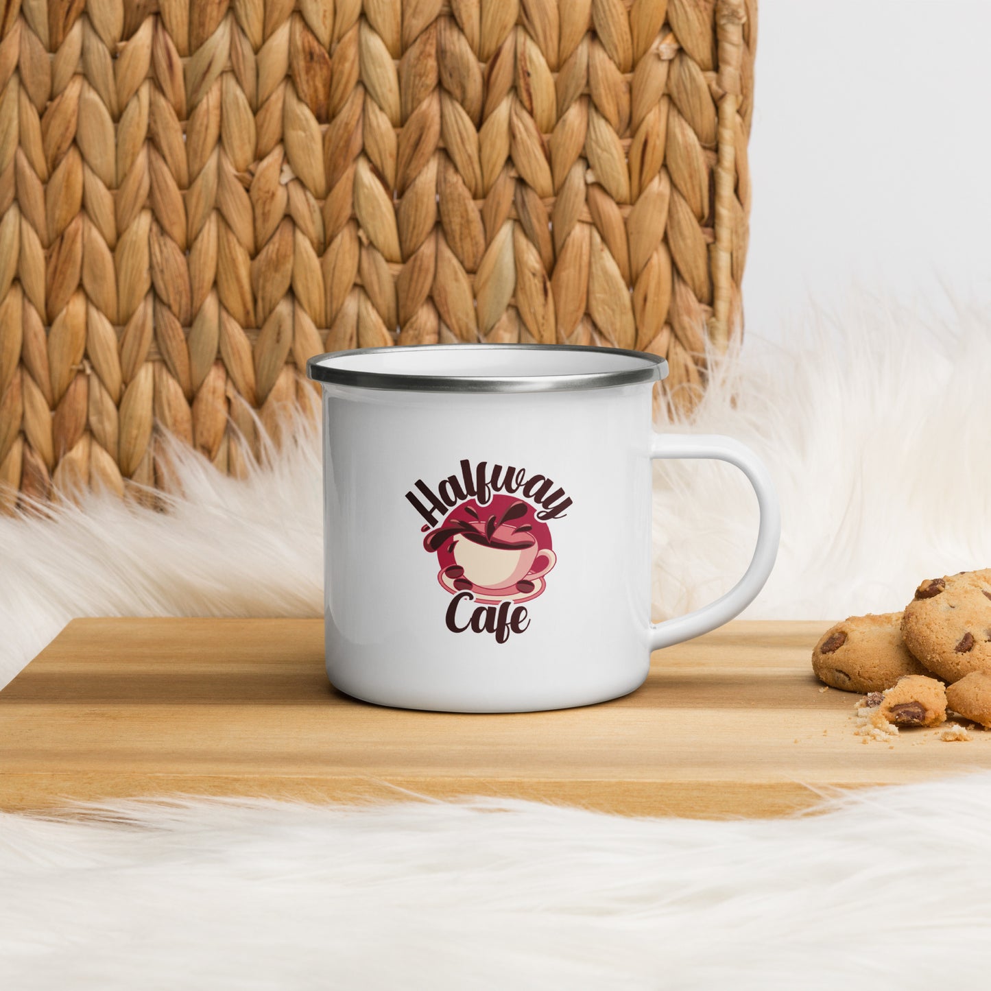 A white enamel mug with the Halfway Cafe Logo. The Halfway Cafe logo features a stylized overflowing cup of coffee, splashing over the side. The words Halfway Cafe are wrapped around the cup.
