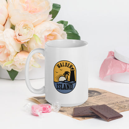 A white coffee mug with the Walden Island Logo. The Walden Island Logo show a stylized sun setting over an island in the sea, with a lighthouse and palm tree on the island. 