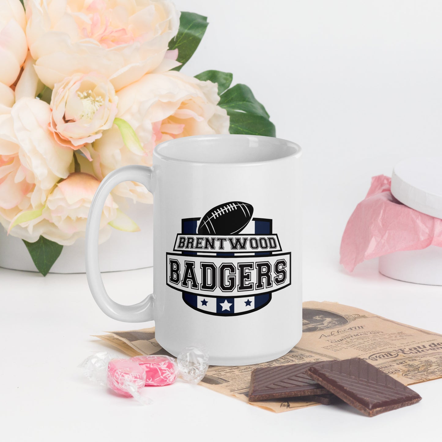 A white mug with a large school crest, showing a football and three stars. The words Brentwood Badgers are printed over the crest 