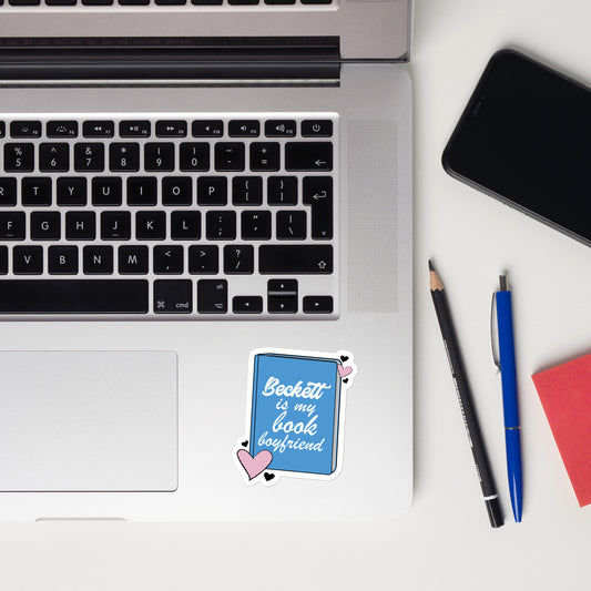 a sticker with the Beckett logo. The Beckett Logo is a blue book with the words Beckett is my book Boyfriend in cursive, with hearts around the book. 