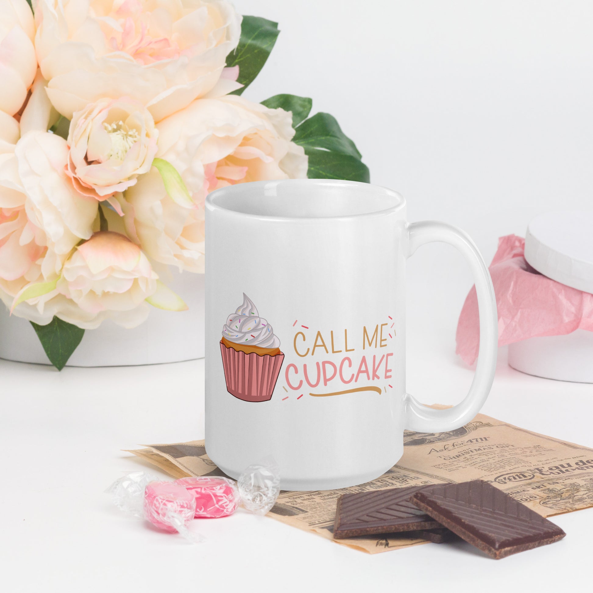a white coffee mug with a cupcake logo and the words Call ME Cupcake