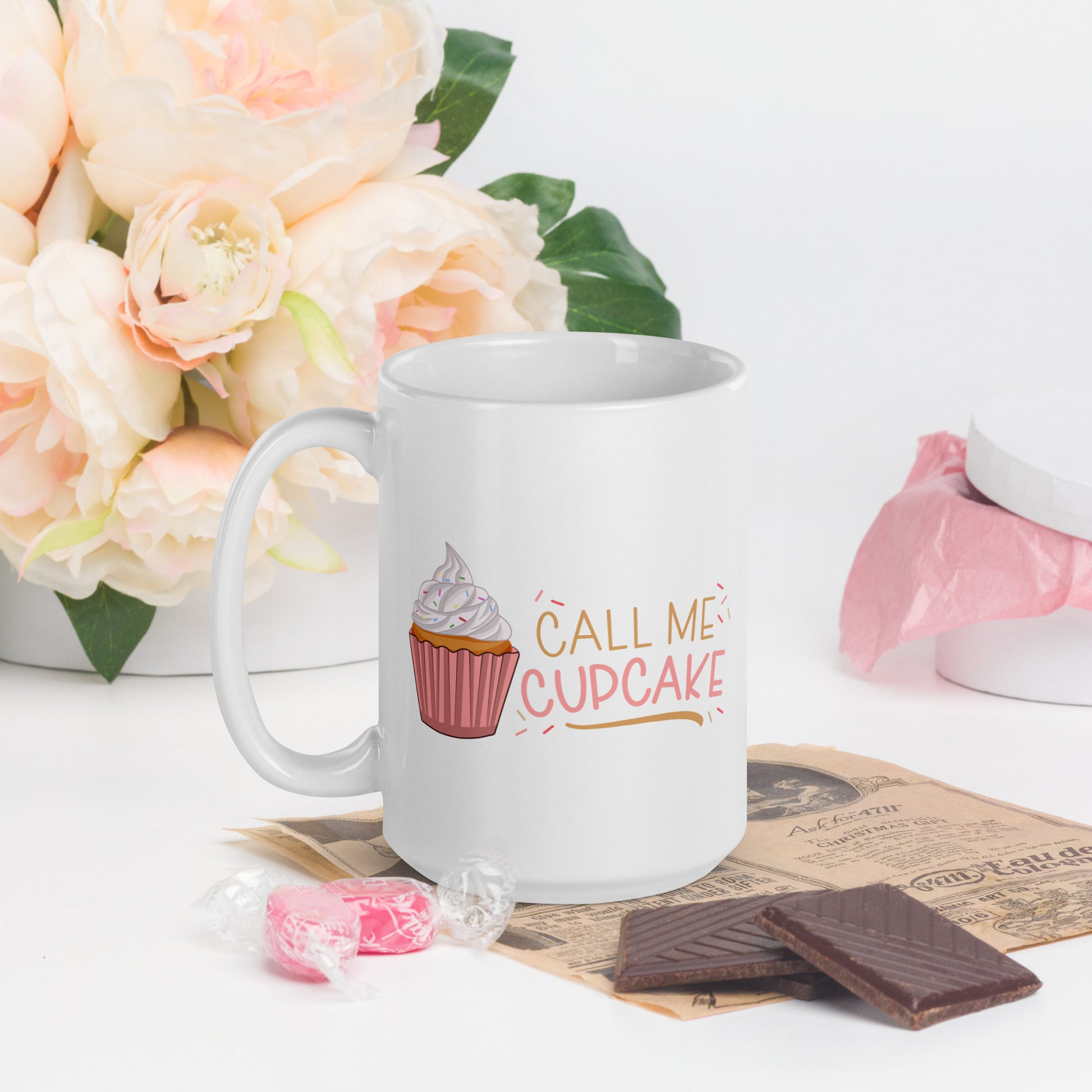 a white coffee mug with a cupcake logo and the words Call ME Cupcake