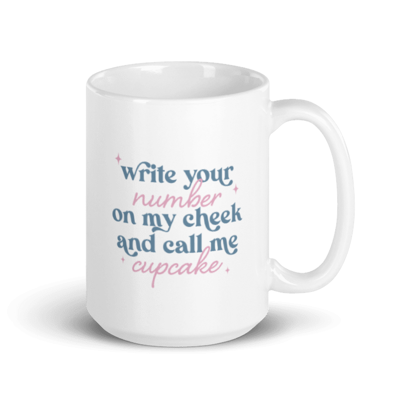 A white coffee mug with pink and blue text that reads "write your number on my cheek and call me cupcake"