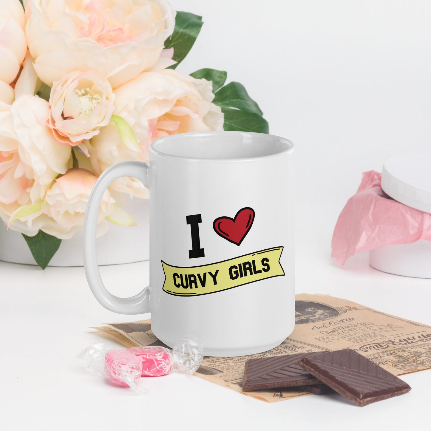 A white coffee mug that reads I Heart Curvy Girls,  with Curvy Girls in a yellow banner