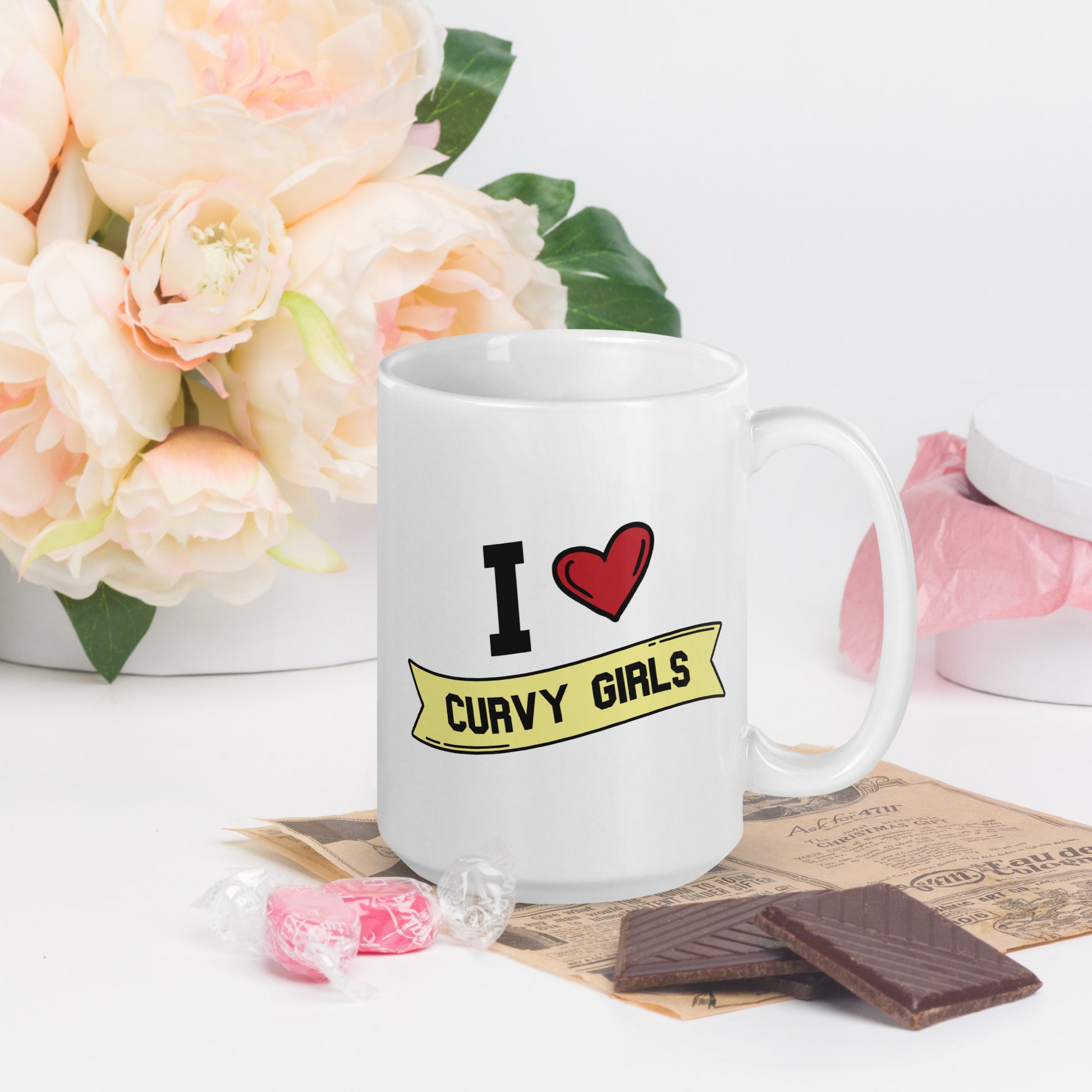 A white coffee mug that reads I Heart Curvy Girls,  with Curvy Girls in a yellow banner