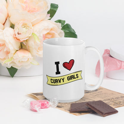 A white coffee mug that reads I Heart Curvy Girls,  with Curvy Girls in a yellow banner