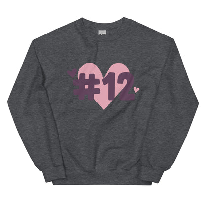 a dark heather crewneck sweatshirt with the I Heart #12 Logo. The Number 12 Logo is a large pink heart with #12 in black written over the heart.