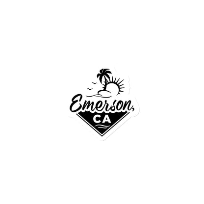 A white and black magnet with the Emrson, California Logo. Showing a beach, the sun and a palm tree