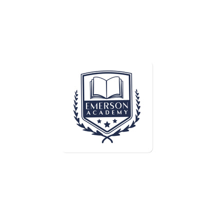 A magnet with the Emerson Academy Logo, a school crest that prominently features an open book