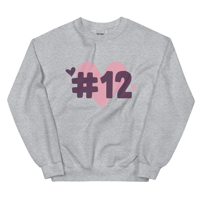 a grey crewneck sweatshirt with the I Heart #12 Logo. The Number 12 Logo is a large pink heart with #12 in black written over the heart.
