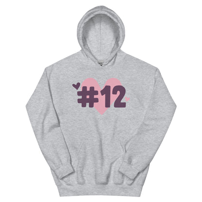a grey hoodie with the I Heart #12 Logo. The Number 12 Logo is a large pink heart with #12 in black written over the heart.