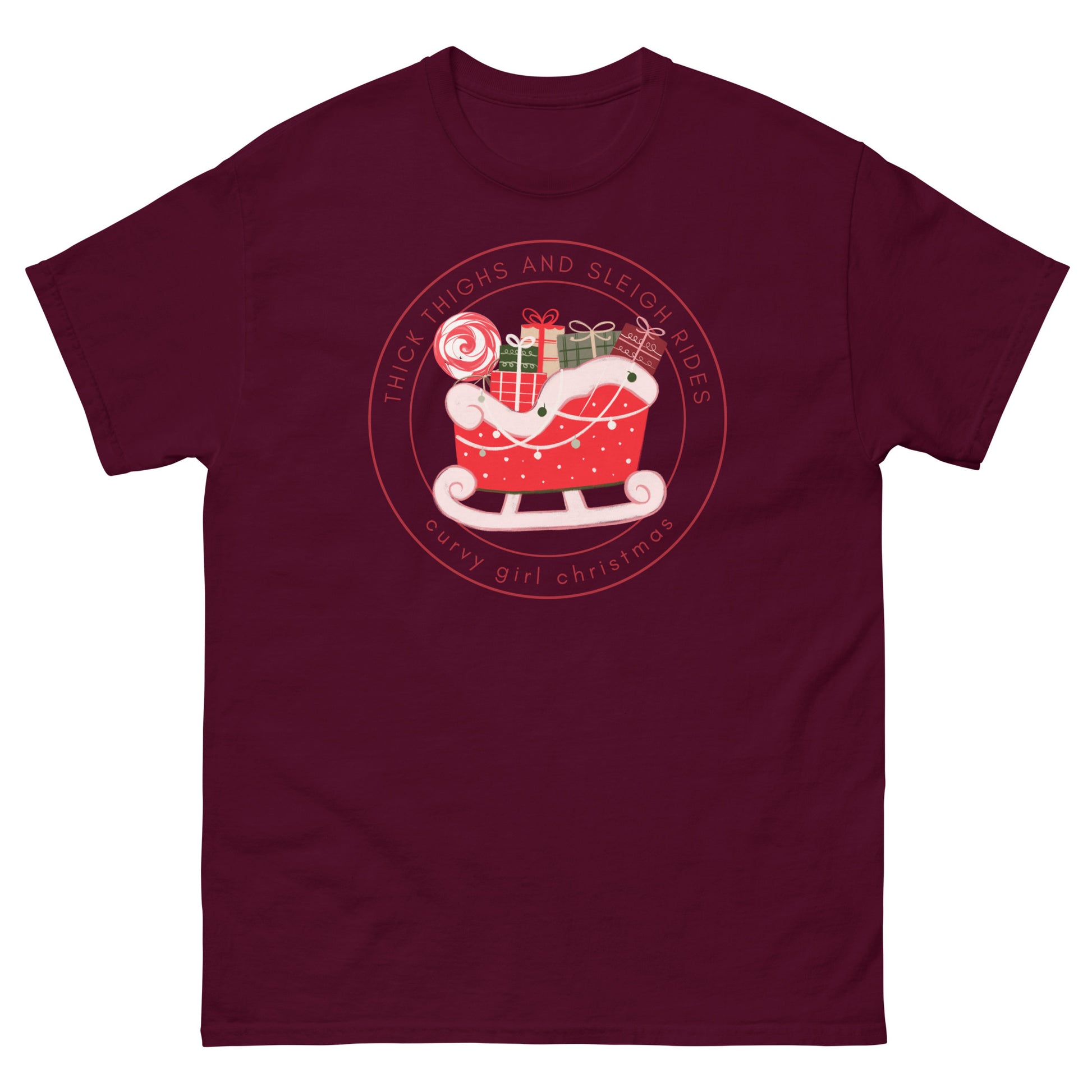 a maroon t-shirt with the Curvy Girl Christmas Sleigh Logo. The logo is a red fluffy sleigh filled with presents, with red lettering circling around that reads Thick Thighs and Sleigh Rides, as well as curvy Girl Christmas
