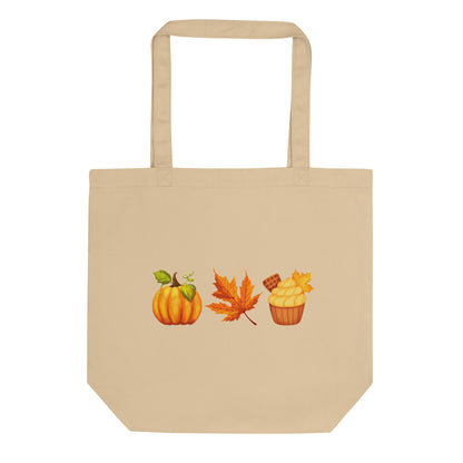 an oyster colored tote bag with a pumpkin, orange leaf and cupcake design