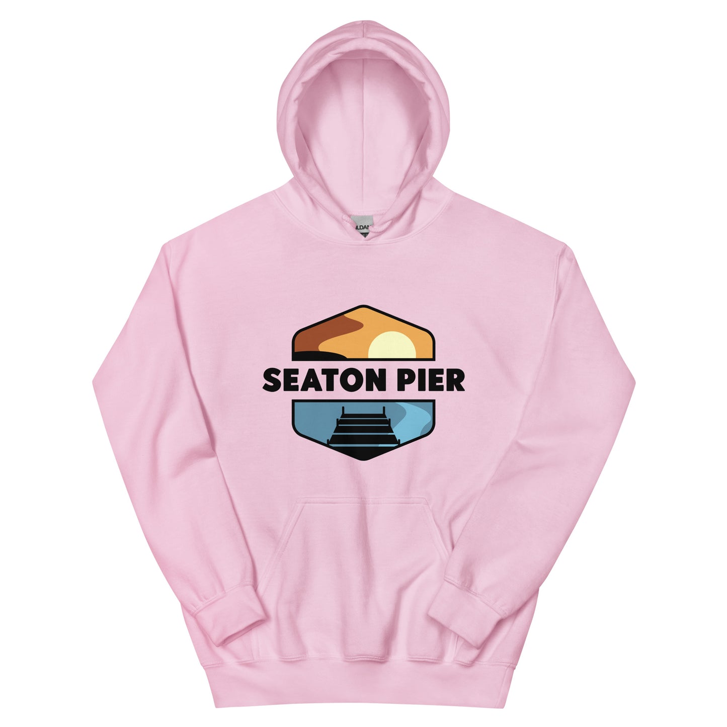 a pink hoodie with the Seaton Pier logo. The Seaton pier logo features the words Seaton Pier separating the sun and the ocean, with a dark pier on the water