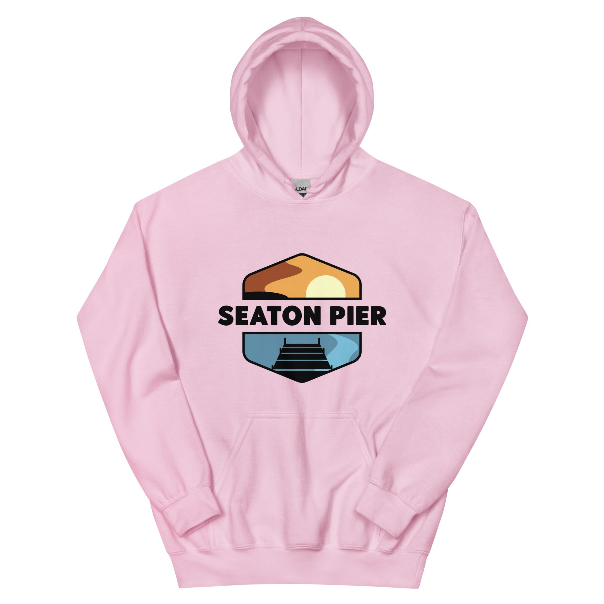 a pink hoodie with the Seaton Pier logo. The Seaton pier logo features the words Seaton Pier separating the sun and the ocean, with a dark pier on the water