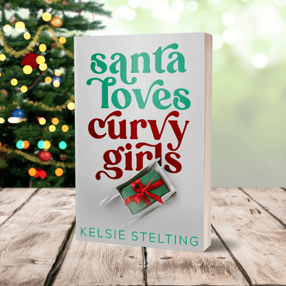 A paperback copy of Santa loves Curvy Girls by Kelsie Stelting