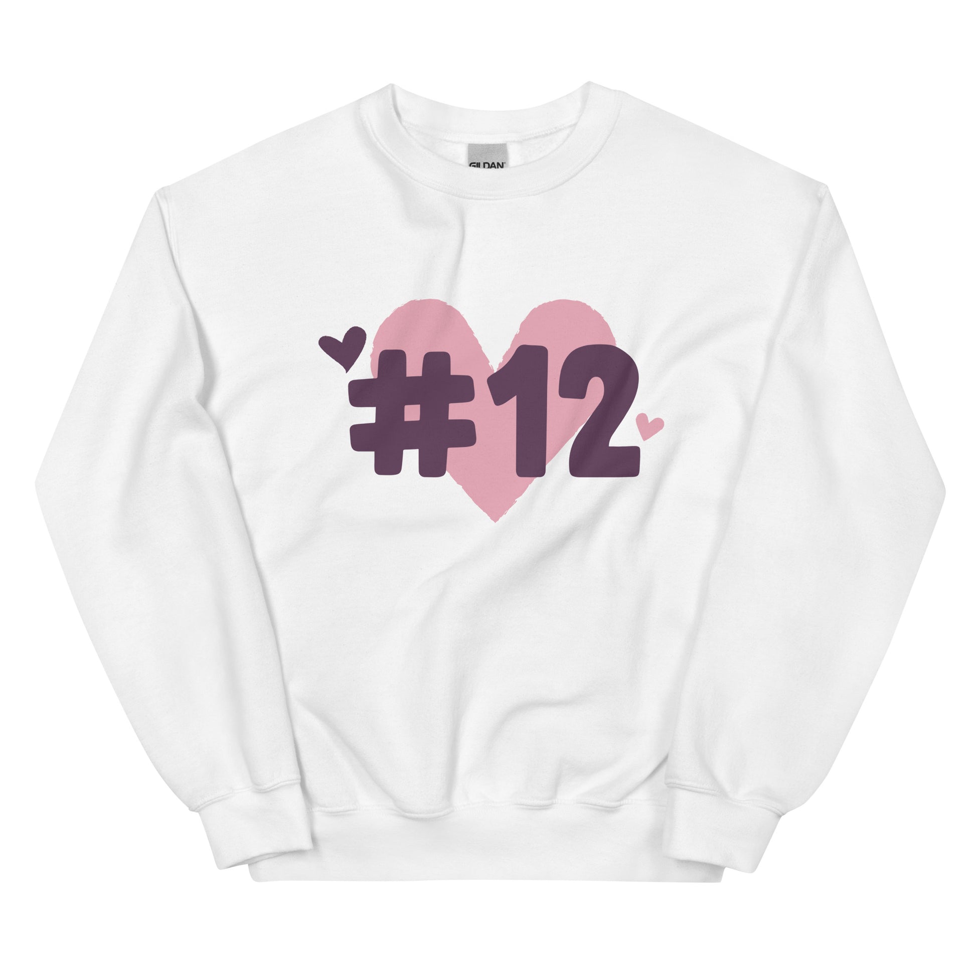 a white crewneck sweatshirt with the I Heart #12 Logo. The Number 12 Logo is a large pink heart with #12 in black written over the heart.