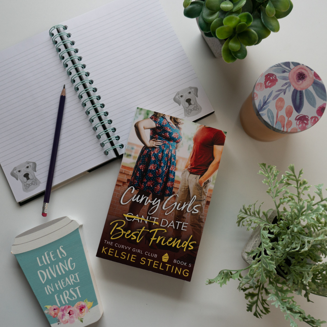 A paperback book. The book's title is Curvy Girls Can't Date Best Friends, The Curvy Girl Club Book 5, by author Kelsie Stelting