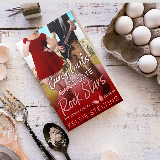 A paperback book. The book's title is Curvy Girls Can't Date Rock Stars, The Curvy Girl Club Book 10 by author Kelsie Stelting